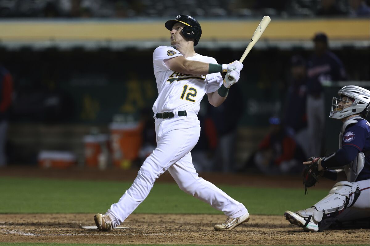 Oakland Athletics' Sean Murphy watches his two-run single in front of Minnesota Twins catcher Ryan Jeffers during the seventh inning of a baseball game in Oakland, Calif., Tuesday, May 17, 2022. (AP Photo/Jed Jacobsohn)