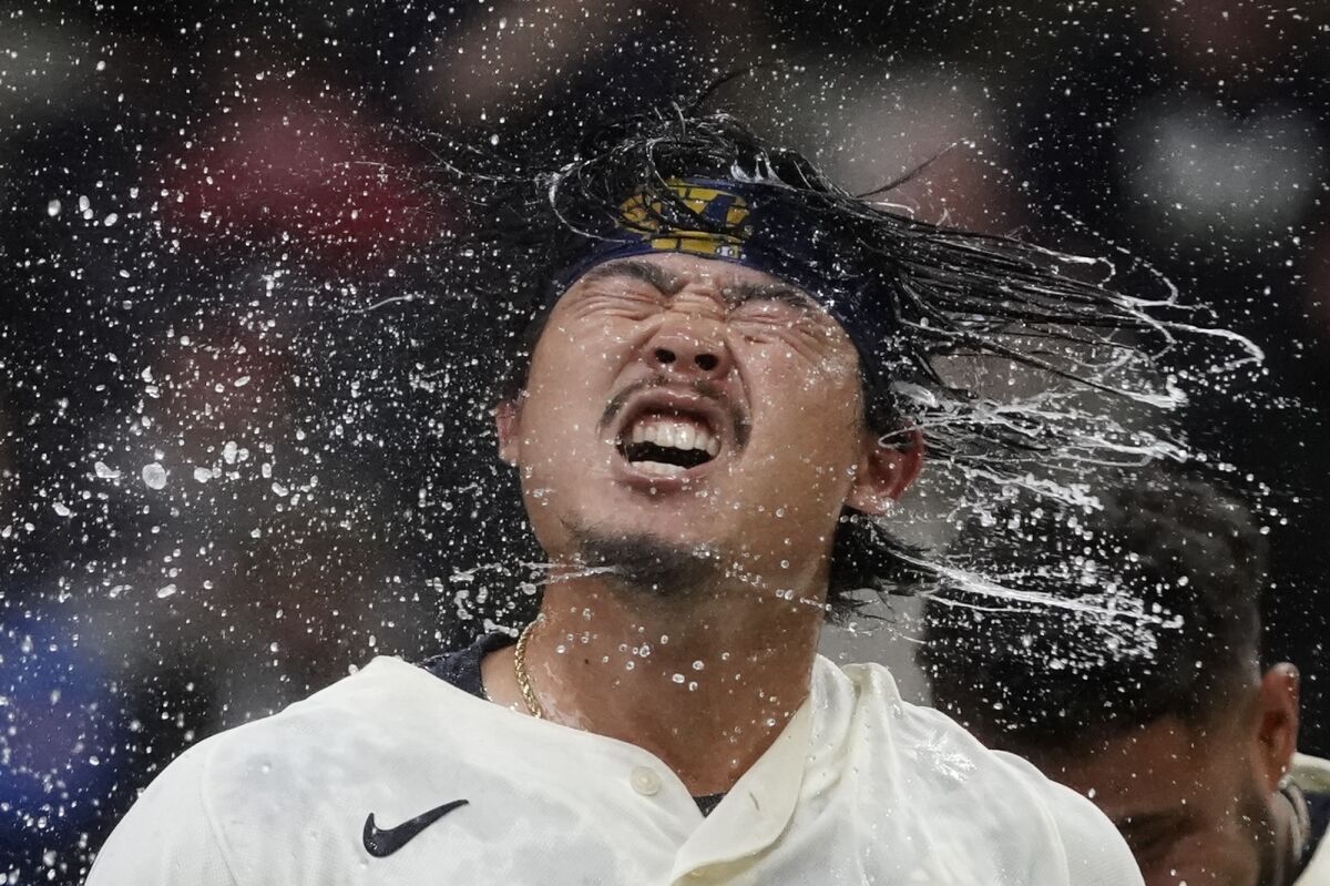 Milwaukee Brewers' Keston Hiura celebrates after hitting a walkoff two-run home run during the 11th inning of a baseball game against the Atlanta Braves Wednesday, May 18, 2022, in Milwaukee. The Brewers won 7-6. (AP Photo/Morry Gash)