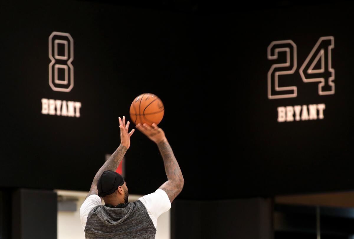 DeMarcus Cousins puts up a shot with Kobe Bryant's Nos. 8 and 24 in the background on Jan. 29 at the Lakers’ practice facility in El Segundo. 