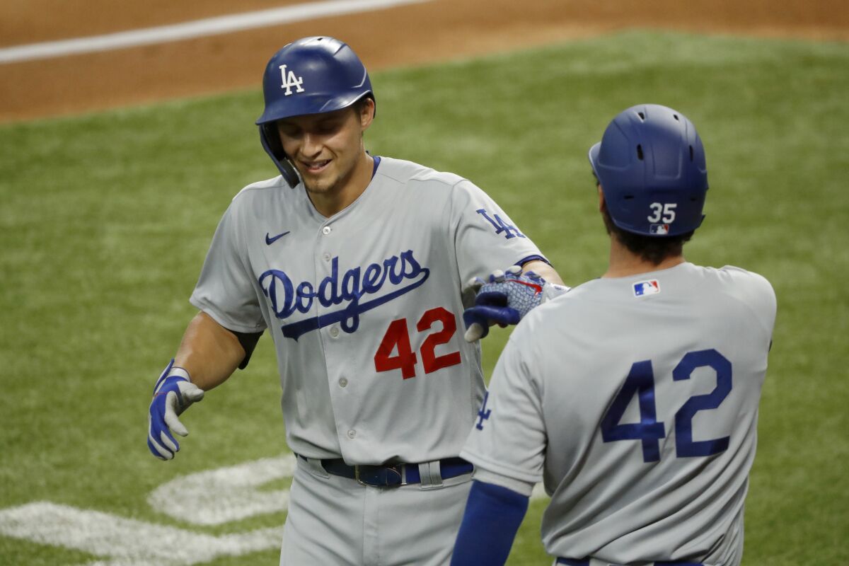 Dodgers shortstop Corey Seager, left, is congratulated by Cody Bellinger after hitting a solo home run.