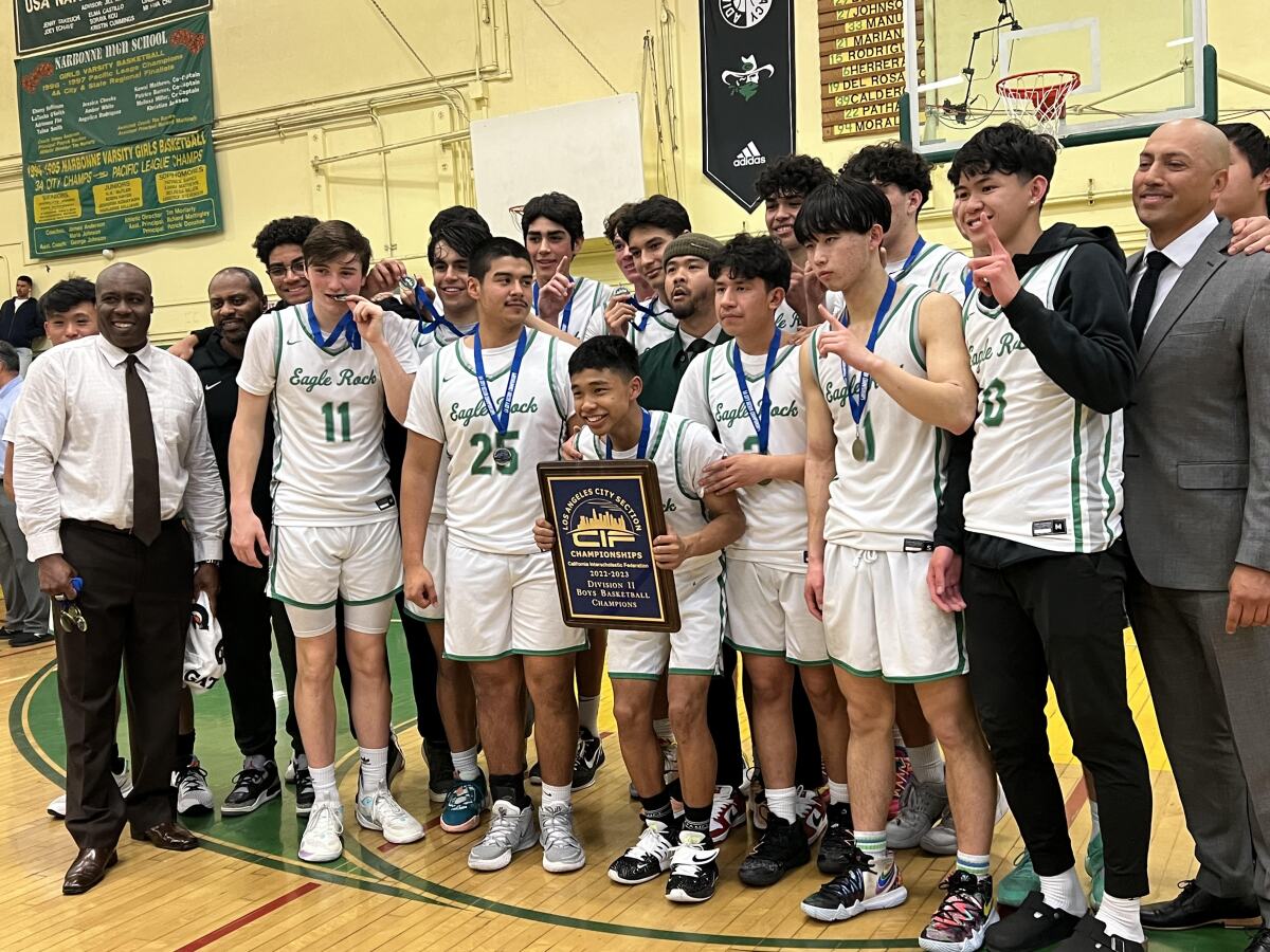 Eagle Rock celebrates winning the City Section Division II championship with 53-49 win over South Gate.