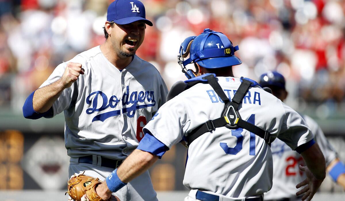 Dodgers catcher Drew Butera celebrates with pitcher Josh Beckett after he struck out Chase Utley to complete a no-hitter on Sunday afternoon in Philadelphia.