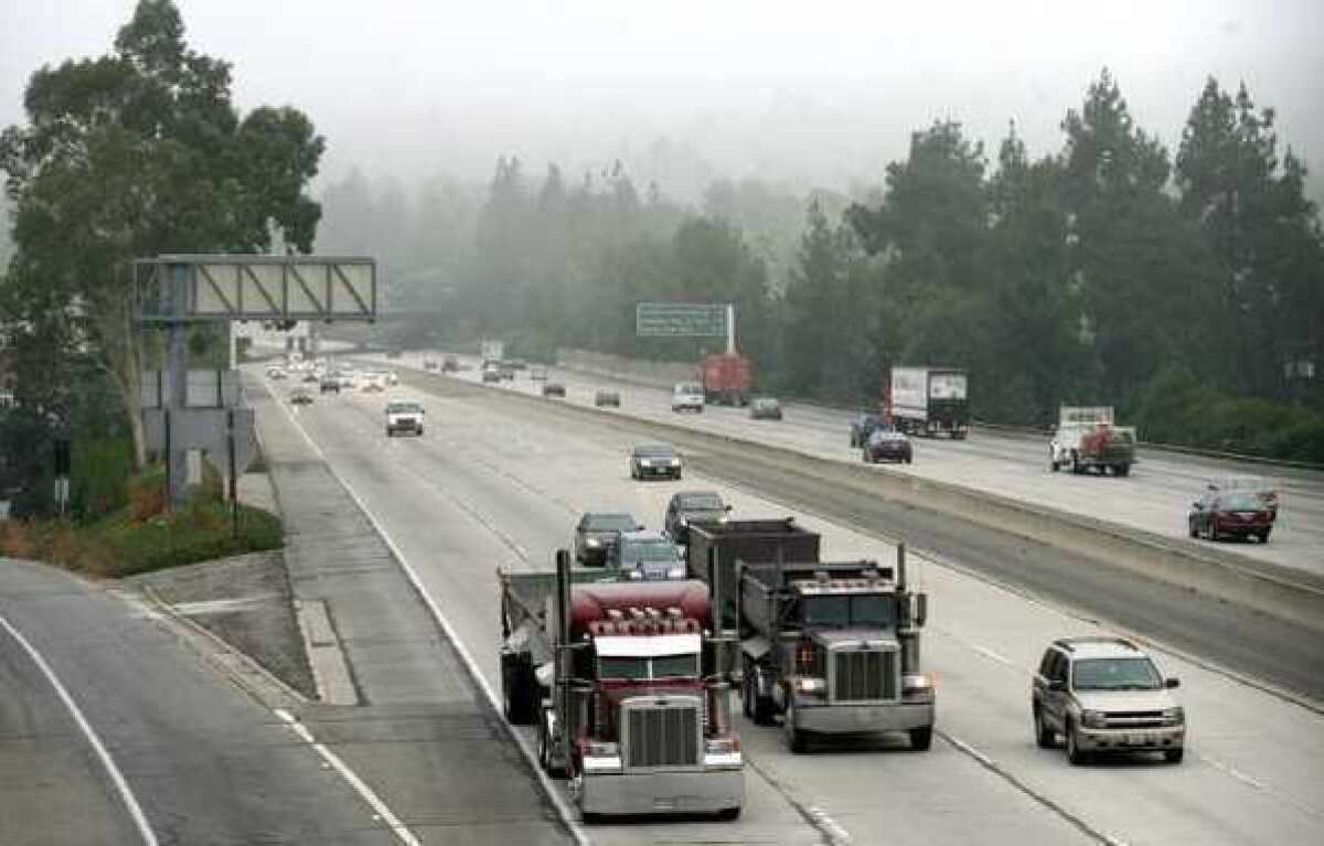 Freeeway traffic moves along the 210 Freeway through La Canada Flintridge at the St. Francis High School overpass.