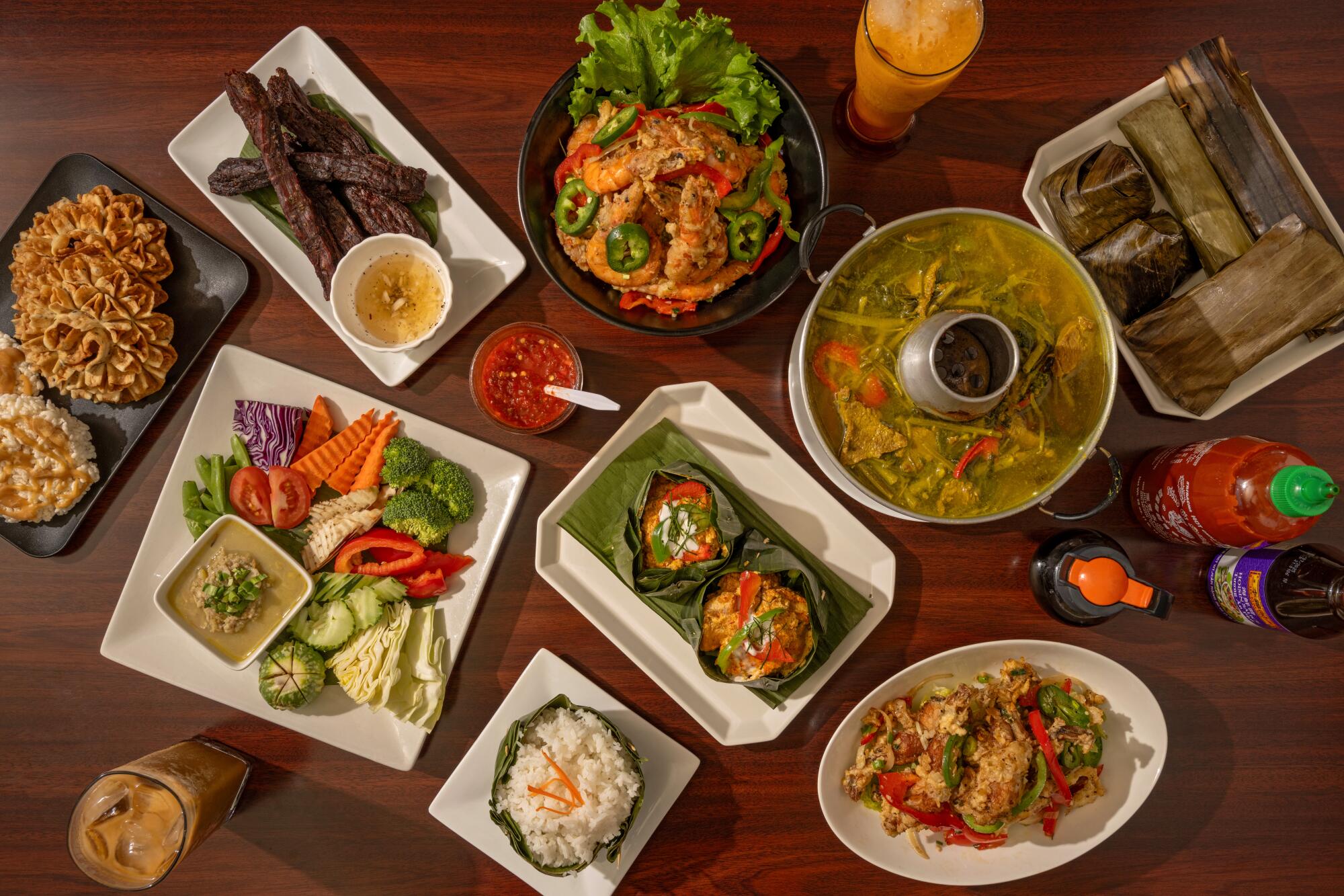 Table spread with various dishes at Sophy's: Cambodia Town Food & Music,