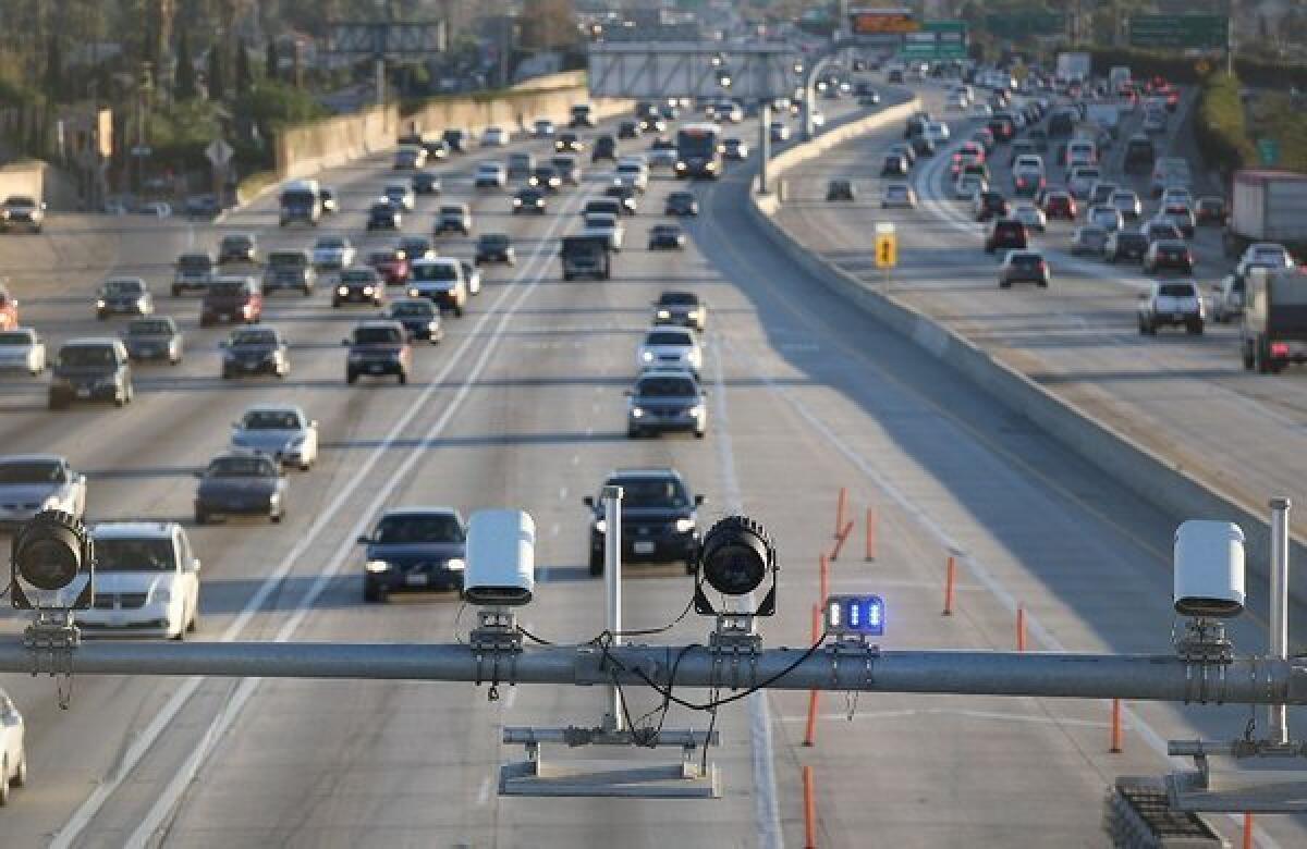 Cameras and electronic sensors stand over the express lane south of the Slauson Avenue transit station on the 110 Freeway.