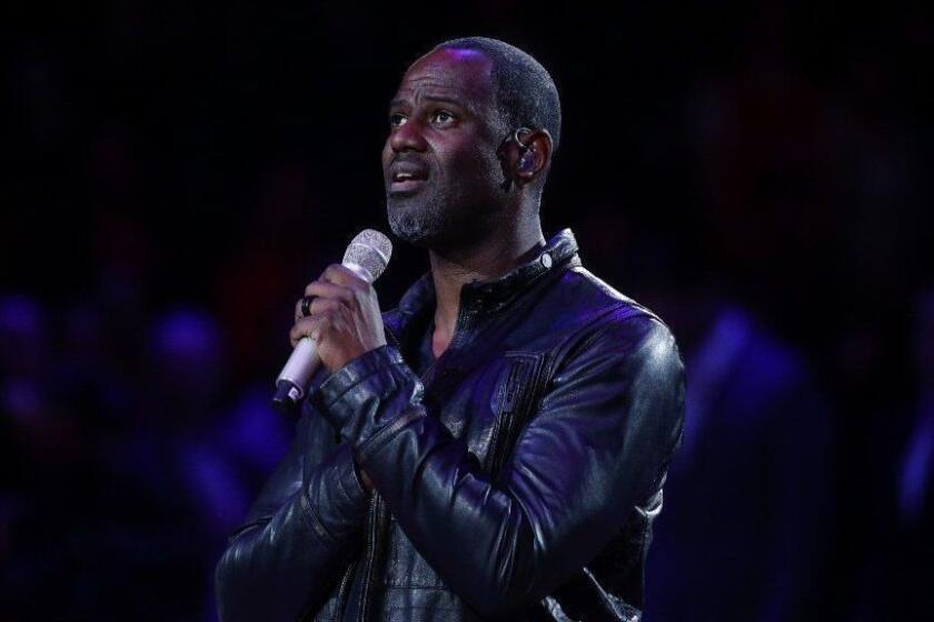 Brian McKnight sings the national anthem before an NBA basketball game between the Los Angeles Clippers and the Memphis Grizzlies, Monday, Feb. 23, 2015, in Los Angeles. (AP Photo/Jae C. Hong)