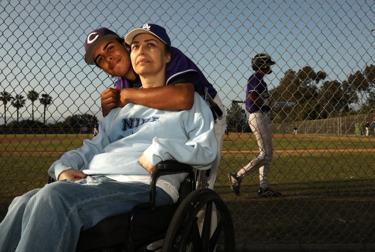 Cathedral High School pitcher Geovanny Hernandez, 17, spends a warm moment with his mother Yovanna Guzman, 44.