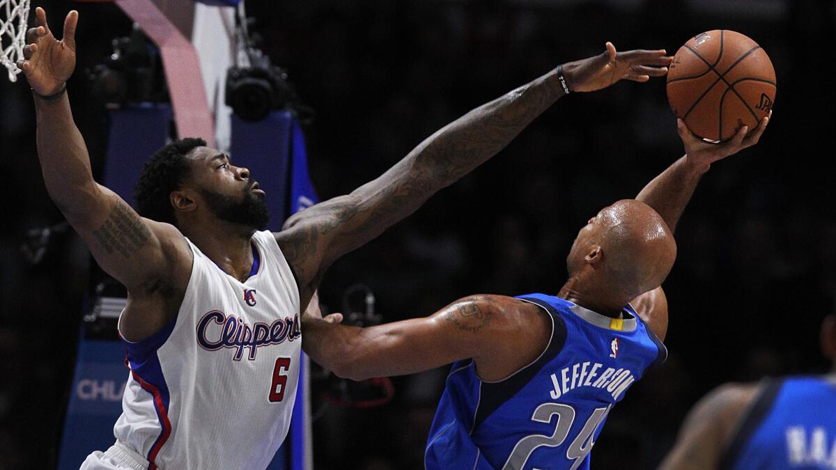 Clippers center DeAndre Jordan, left, tries to block a shot by Dallas Mavericks forward Richard Jefferson during the first half of a Jan. 10, 2015, game at Staples Center.