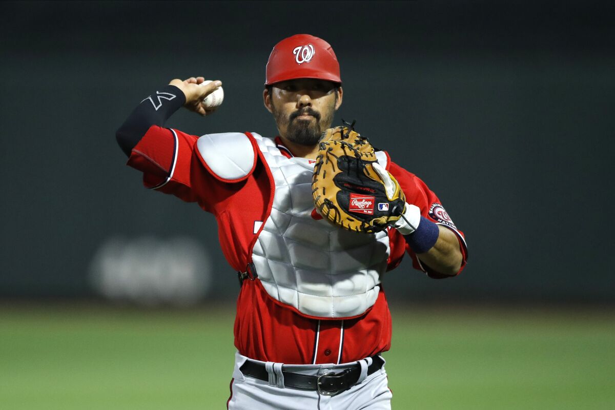 Washington Nationals catcher Kurt Suzuki warms up before an exhibition game against the Miami Marlins in March 2020.