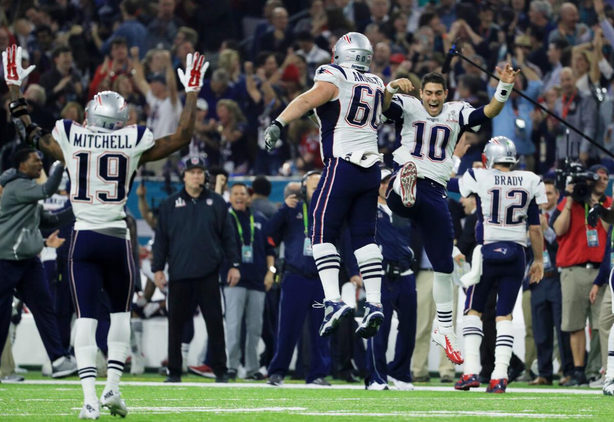 New England Patriots players celebrate after defeating the Atlanta Falcons in overtime of Super Bowl LI.