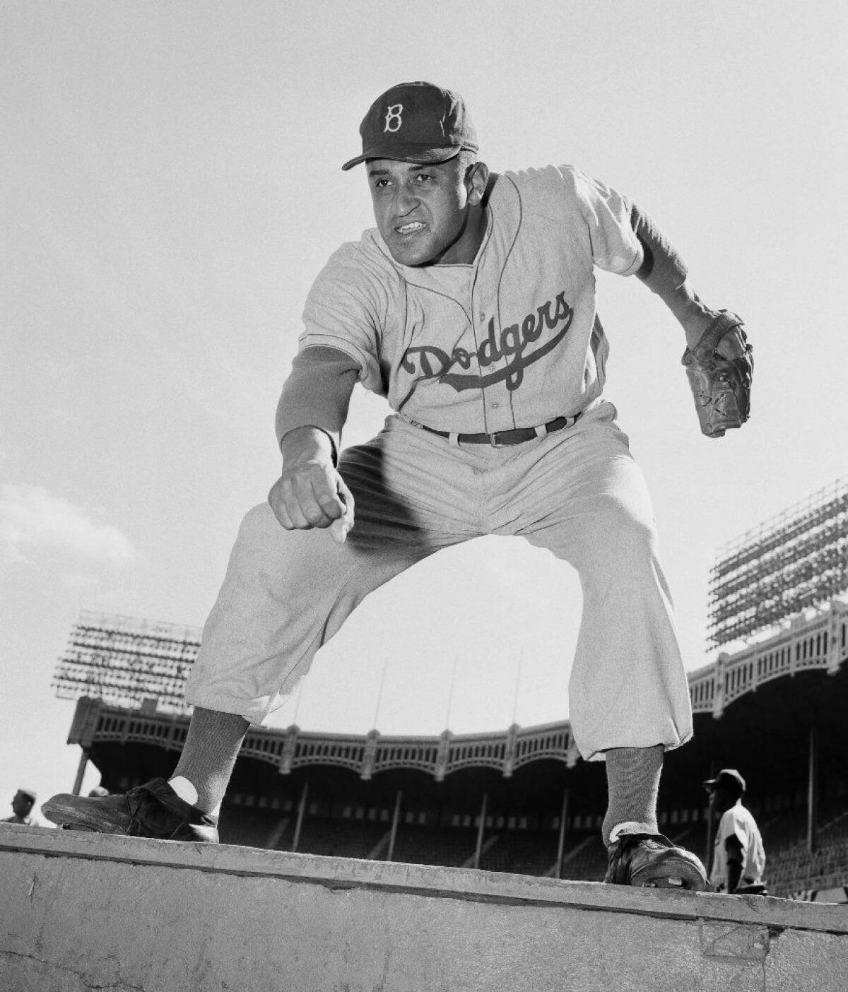 The Brooklyn Dodgers' Don Newcombe, shown on Sept. 28, 1955, poses against the backdrop of Yankee Stadium.