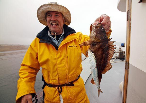 Bill Hopper displays his rockfish, which he released back to the sea. He was on the maiden voyage of Toss Back Tuesdays, an experiment aimed at changing the business model for saltwater outings in order to help sustain sport fishing and aid the recovery of fish stocks. See full story