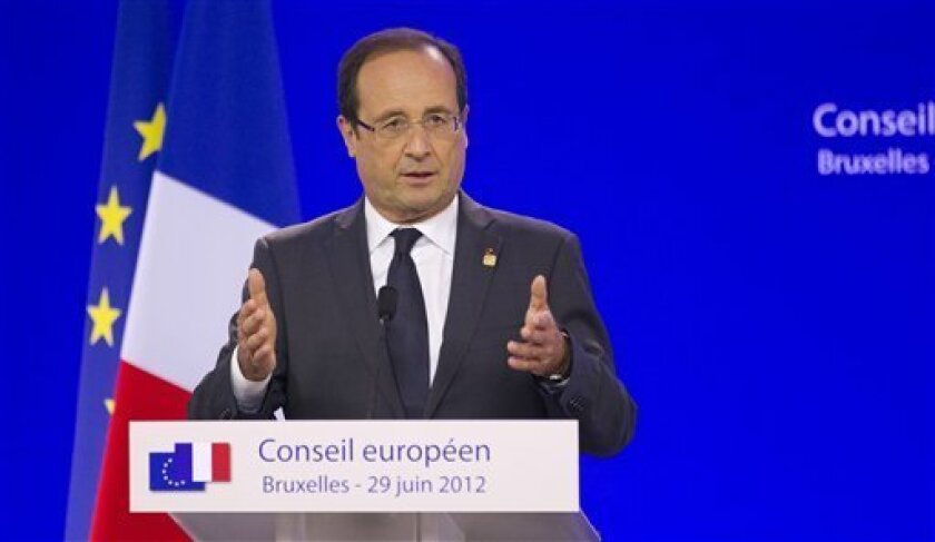 French President Francois Hollande gestures while speaking during a media conference at an EU Summit in Brussels on Friday, June 29, 2012. European leaders have agreed to use the continent's permanent bailout fund to recapitalize struggling banks, and agreed to the idea of a tighter union in the long term. (AP Photo/Michel Euler)