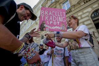 Swifties trade bracelets in the city centre in Vienna on Thursday, Aug.8, 2024. Organizers of three Taylor Swift concerts in the stadium in Vienna this week called them off on Wednesday after officials announced arrests over an apparent plot to launch an attack on an event in the Vienna area such as the concerts. (AP Photo/Heinz-Peter Bader)