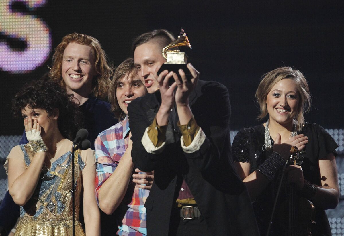 Win Butler of Arcade Fire accepts their Grammy for Album of the Year at the 53rd Annual Grammy Awards.
