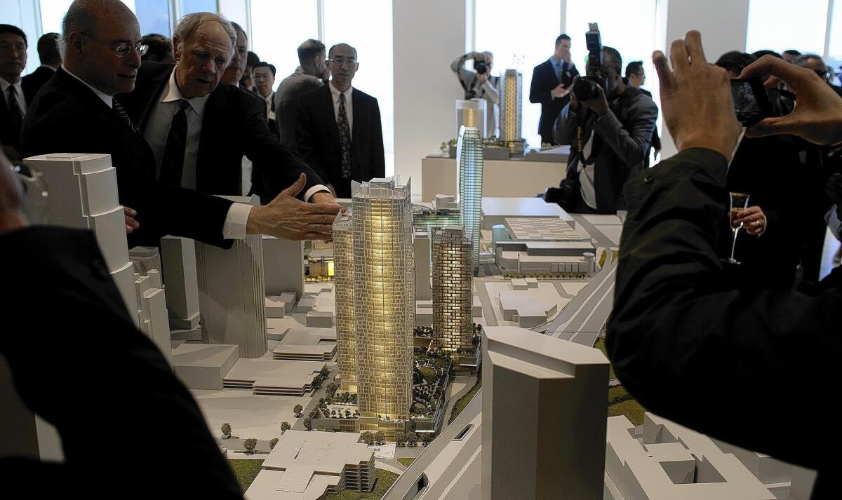 A model of the Metropolis, a 350-room hotel and residential tower proposed for downtown Los Angeles, is shown. The developer, Greenland US Holding Inc., says it needs as much as $92 million in financial help to fill a budget gap in the project, according to a report prepared for the City Council.