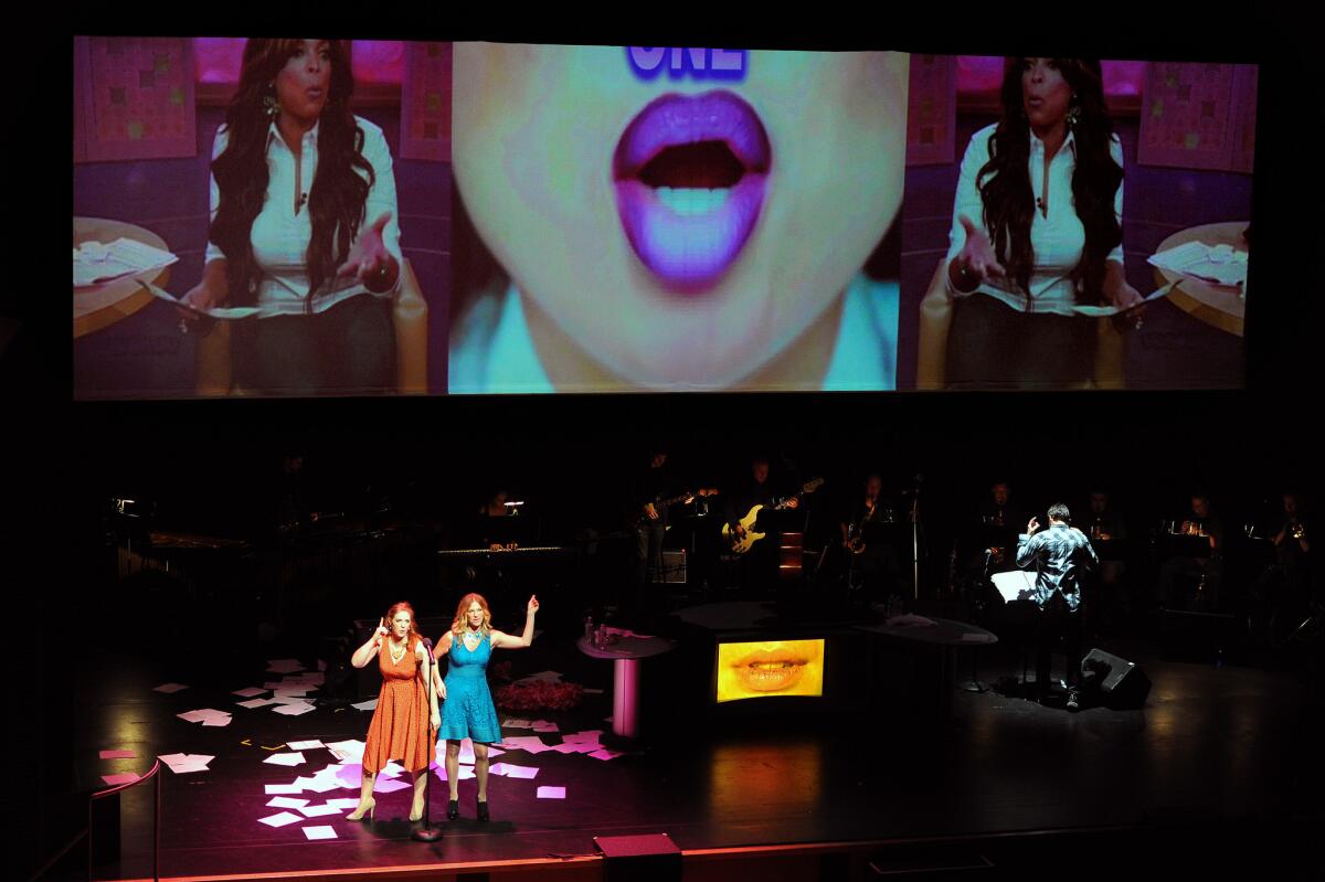 Soprano Maeve Höglund, left, and rhythm vocalist Loire Cotler in the Long Beach Opera production of JacobTV's "The News" at the Broad Stage.