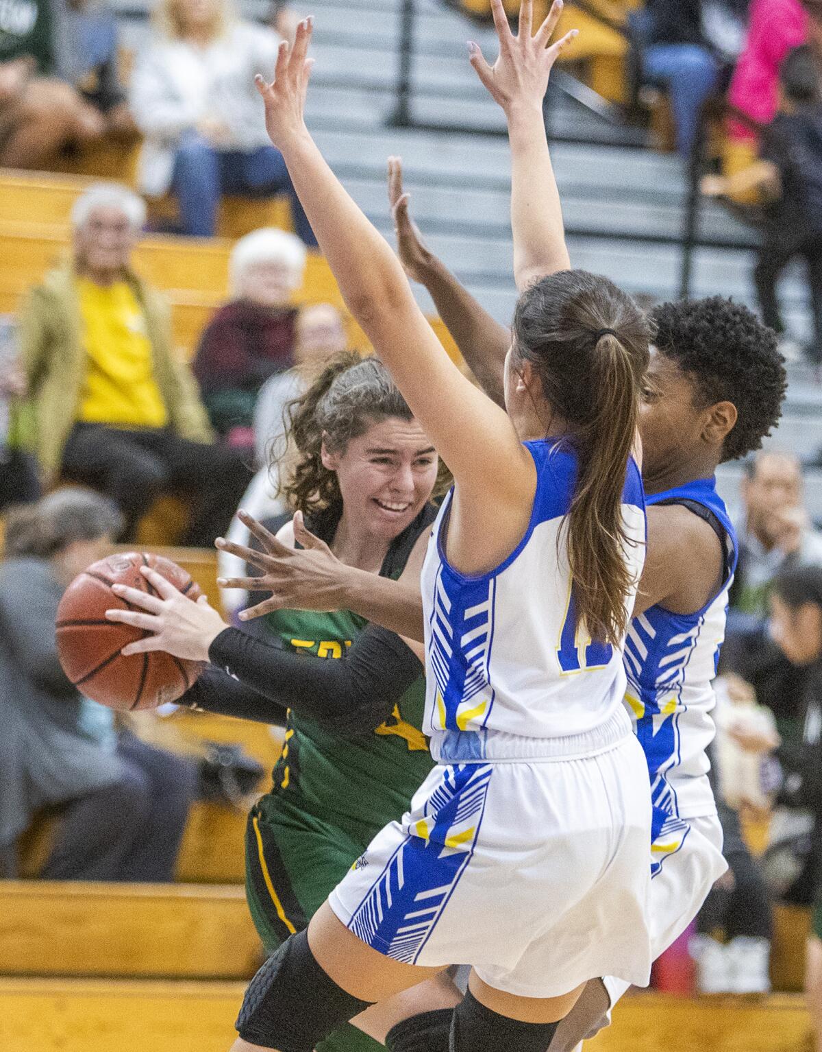 Fountain Valley's Audrey Tengan, center, and Tatiana Sagon, right, attempt to trap Edison's Madison Copeland during a Sunset Conference crossover game on Jan. 2.