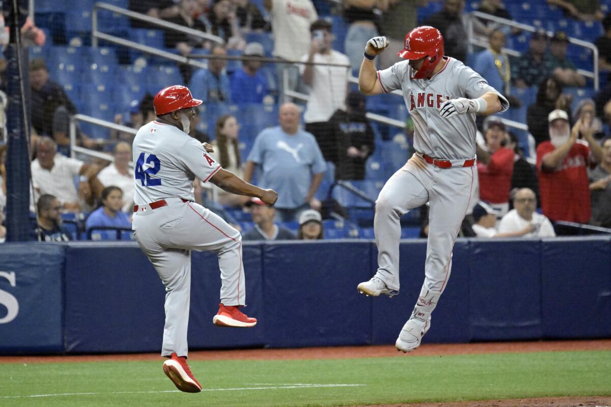 Angels star Mike Trout, right, celebrates with third base coach Eric Young Sr. after hitting a two-run home run.