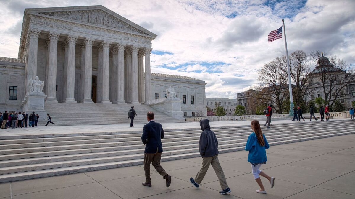 Visitors arrive at the Supreme Court. The case before the justices involved two defendants in Colorado.