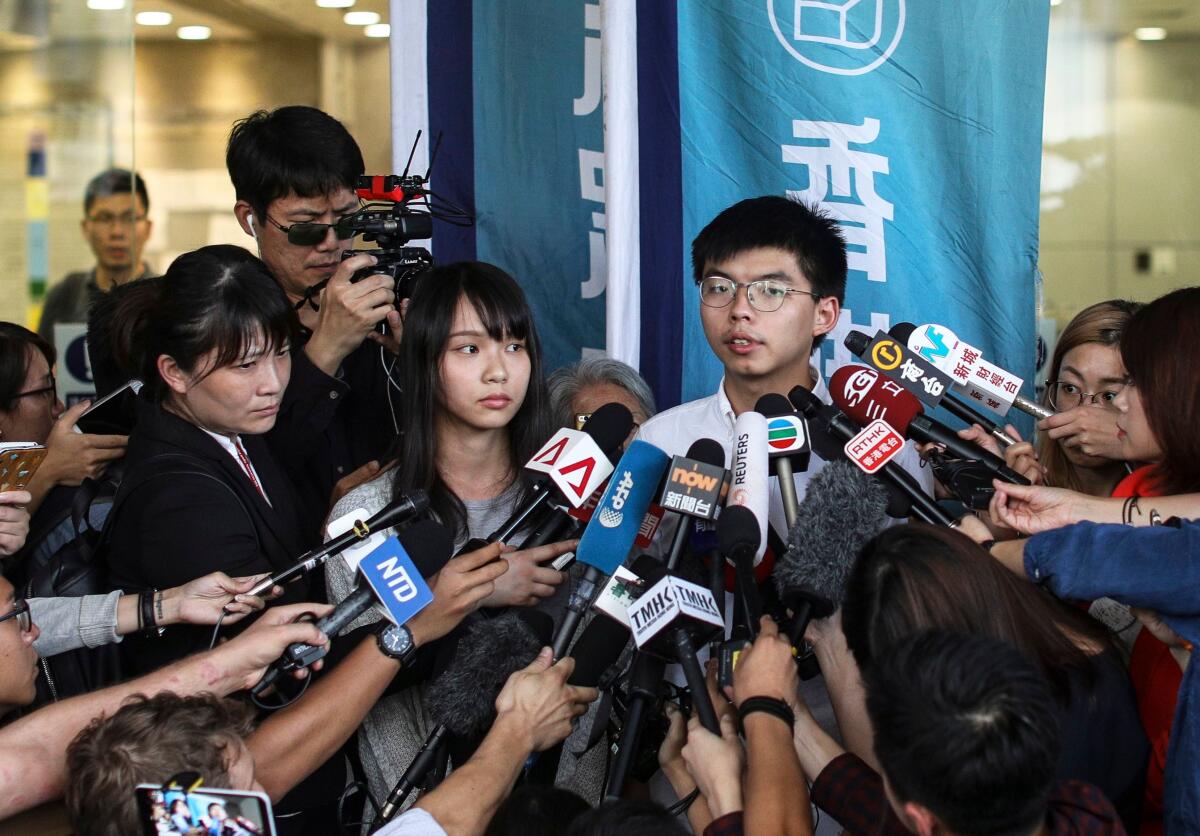 Demosisto leaders Joshua Wong (C-R) and Demosisto member Agnes Chow (C-L) speak to the press after they were released on bail in Wan Chai police headquarters, Hong Kong, China, 30 August 2019, for their involvement in an unlawful assembly during the besieging of the Wan Chai police headquarters on June 21.