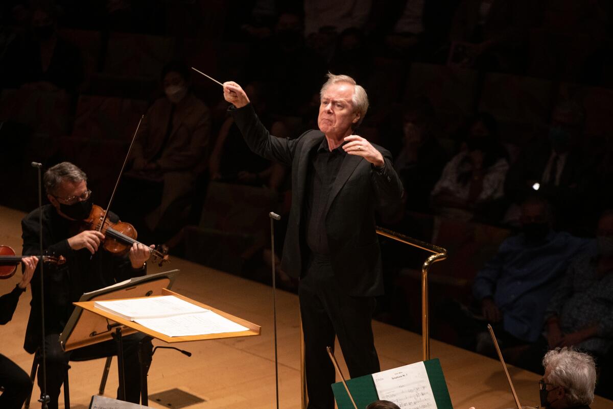 A conductor works with an orchestra