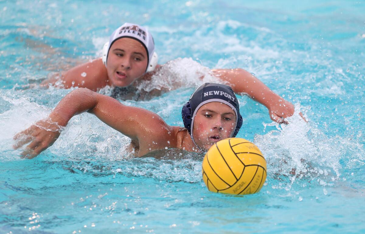 Newport Harbor's Billy Rankin (11) chases down a ball during Wednesday's Surf League water polo game versus Huntington Beach.