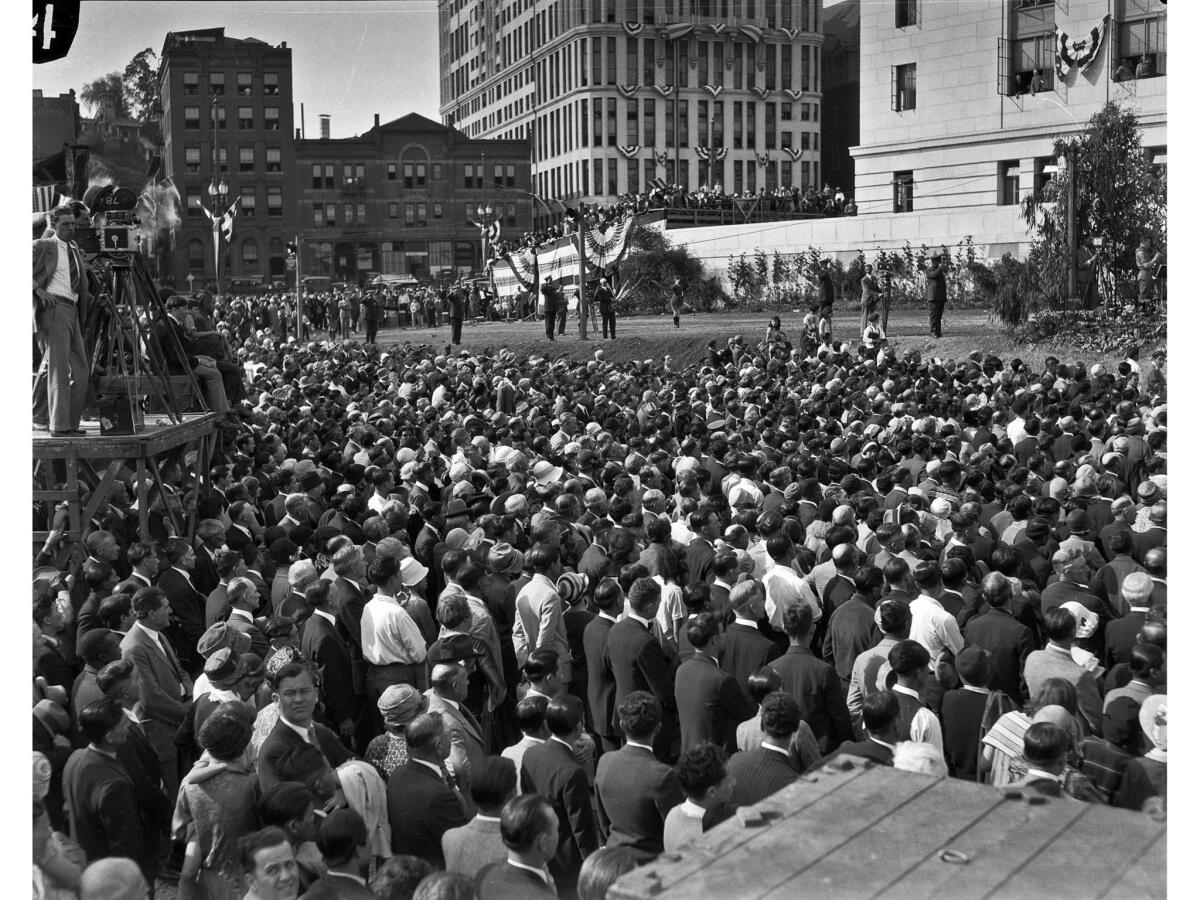 April 26, 1928: Crowd at Los Angeles City Hall dedication ceremonies. The program was on the South Terrace of City Hall. The buildings in background are on Spring Street. News cameras are on left.