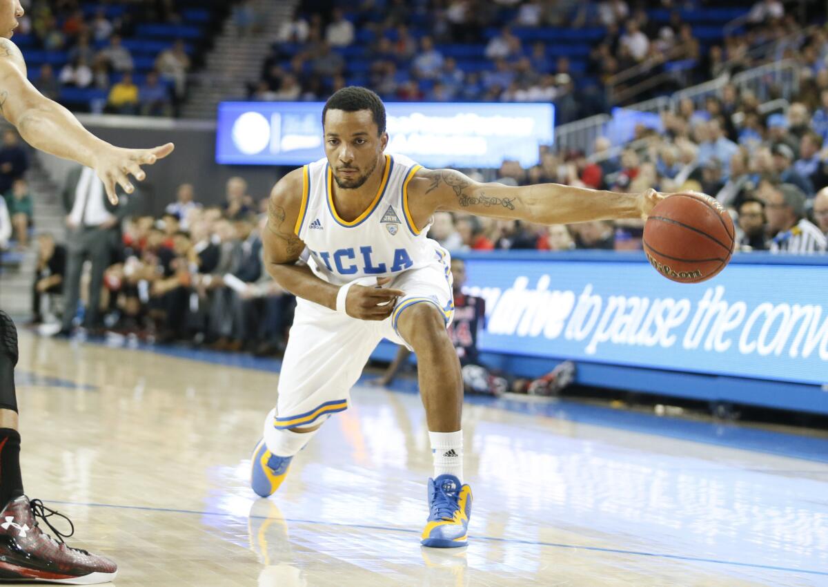 UCLA guard Norman Powell passes the ball inside. Passing has been key for the UCLA Bruins run to the Sweet 16.