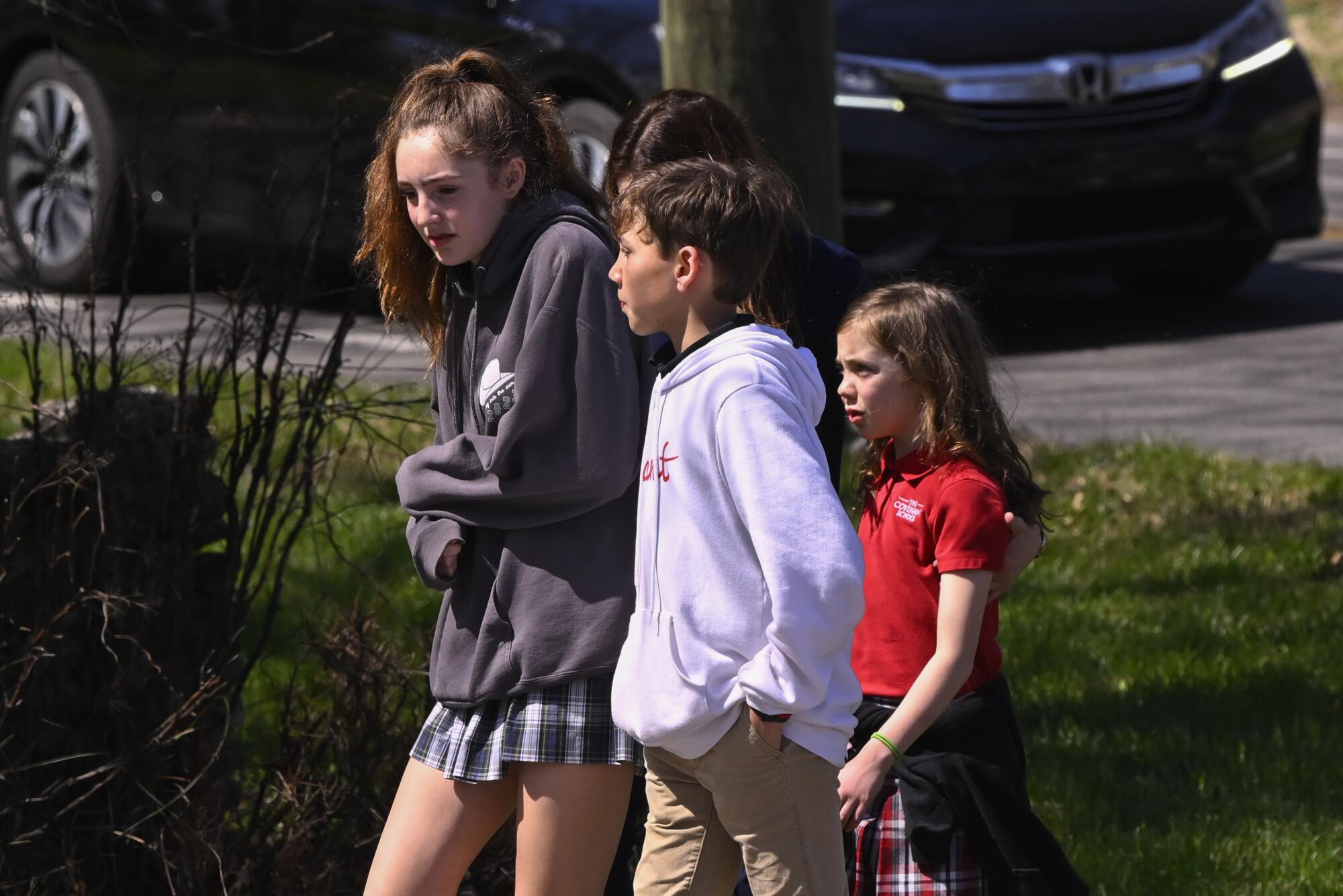 Three students walk together.