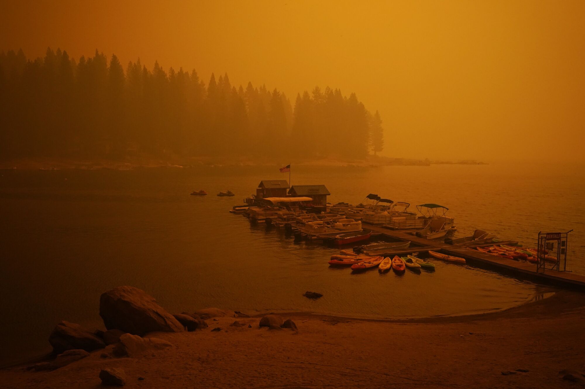 Smoke from the Creek fire shrouds a boat dock on Sunday at Shaver Lake, Calif. 