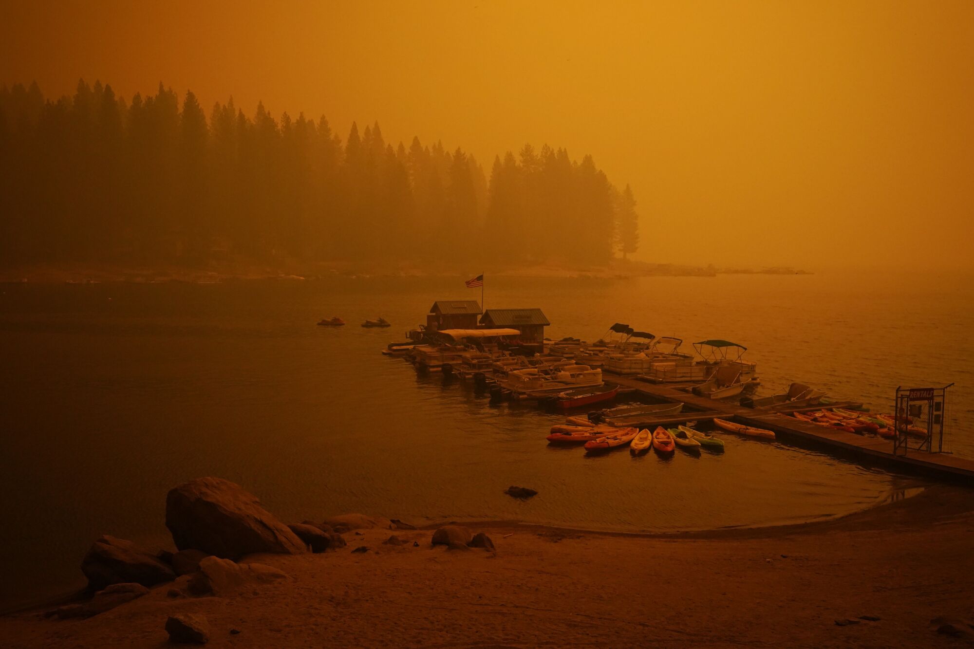 Smoke from the Creek fire shrouds a boat dock on Sunday at Shaver Lake, Calif.