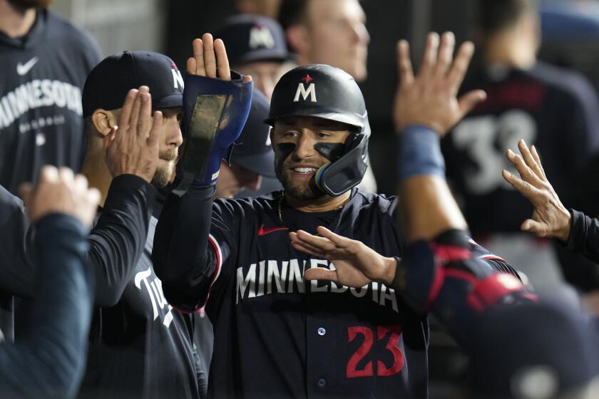 Minnesota Twins' Royce Lewis celebrates in the dugout after scoring on single from Carlos Correa during during the eighth inning of a baseball game against the Chicago White Sox, Saturday, Sept. 16, 2023, in Chicago. (AP Photo/Erin Hooley)