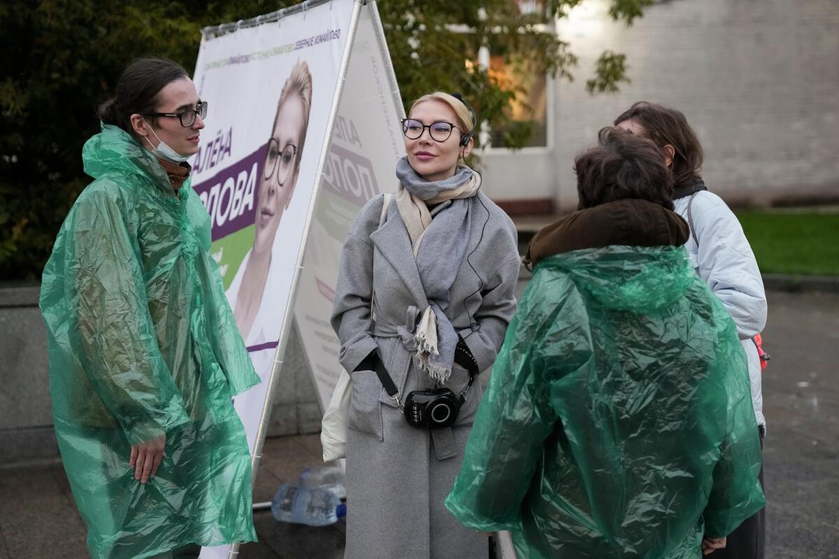 Alyona Popova, the democratic Yabloko party candidate for the State Duma, center, is surrounded by her campaign's team members, during a meeting with voters in Moscow, Russia, Friday, Sept. 3, 2021. One of the country’s most ardent feminists, Popova has fought for years without success to get members of the State Duma to draft legislation to protect women. So she decided to run herself in the Sept. 19 election. (AP Photo/Pavel Golovkin)