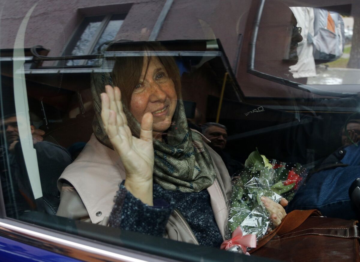 Belarusian writer Svetlana Alexievich leaves a news conference after being named the winner of the 2015 Nobel Prize in literature.