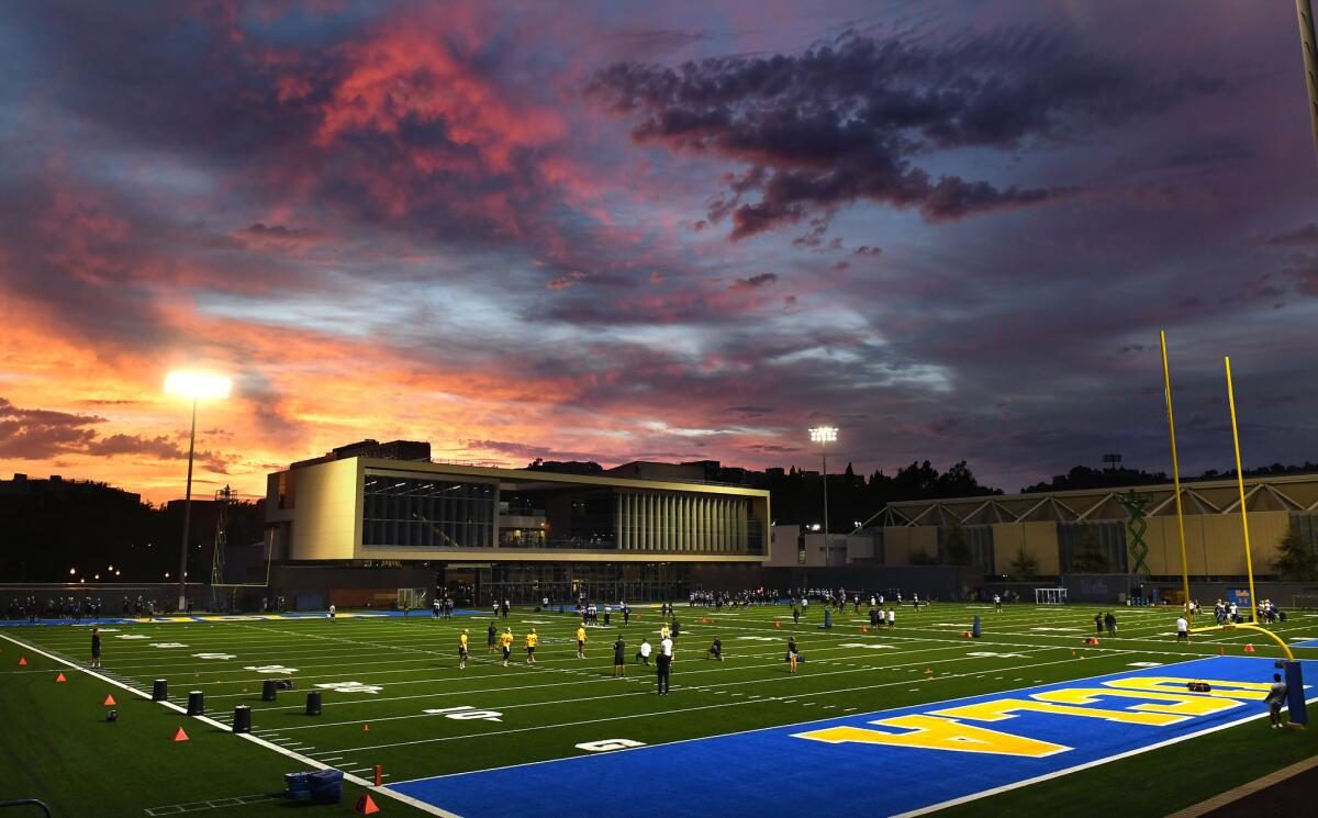 Football players practice at Spaulding Field on the UCLA campus.