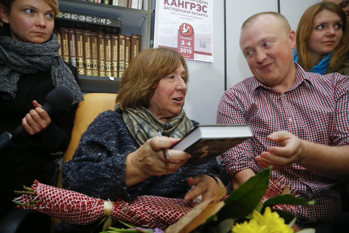 Svetlana Alexievich signs autographs after her news conference in Minsk.