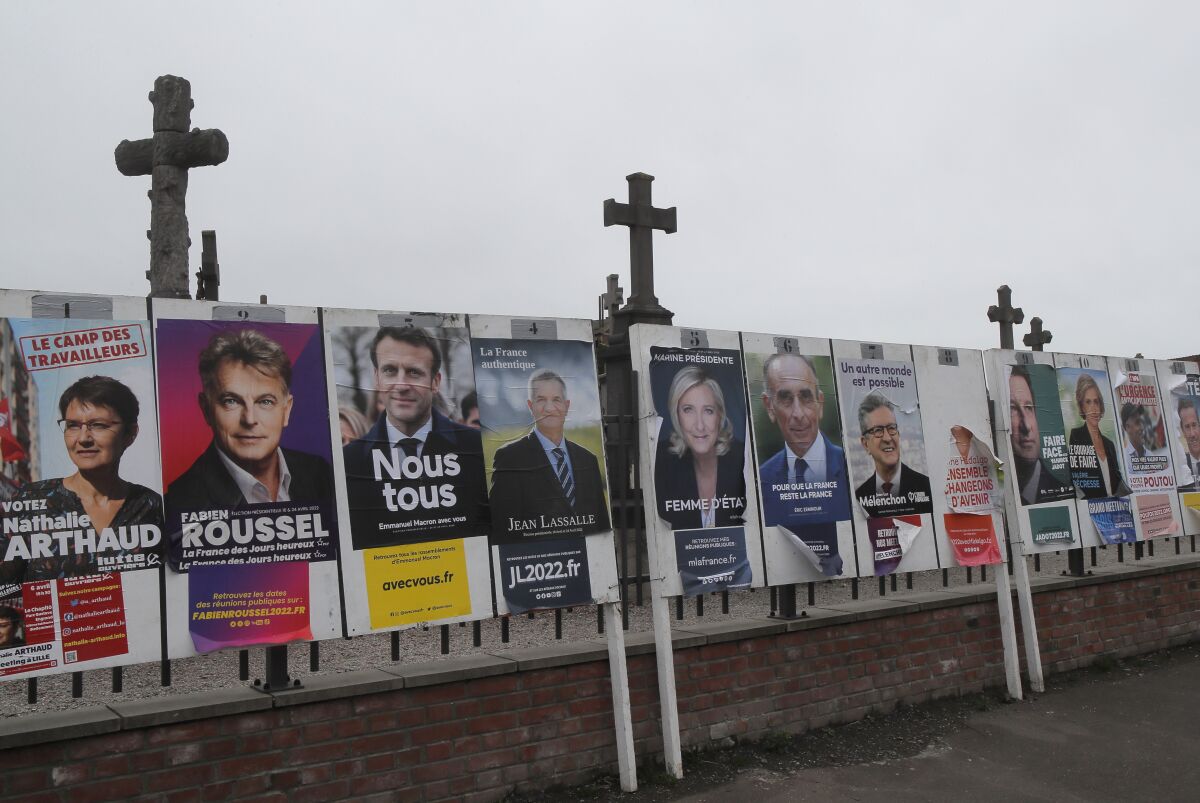 Electoral posters displaying the presidential candidates is displayed in Aubers, northern France, Friday, April 8, 2022. France's first round of the presidential election takes place on April 10, with a presidential runoff on April 24 if no candidate wins outright. (AP Photo/Michel Spingler)
