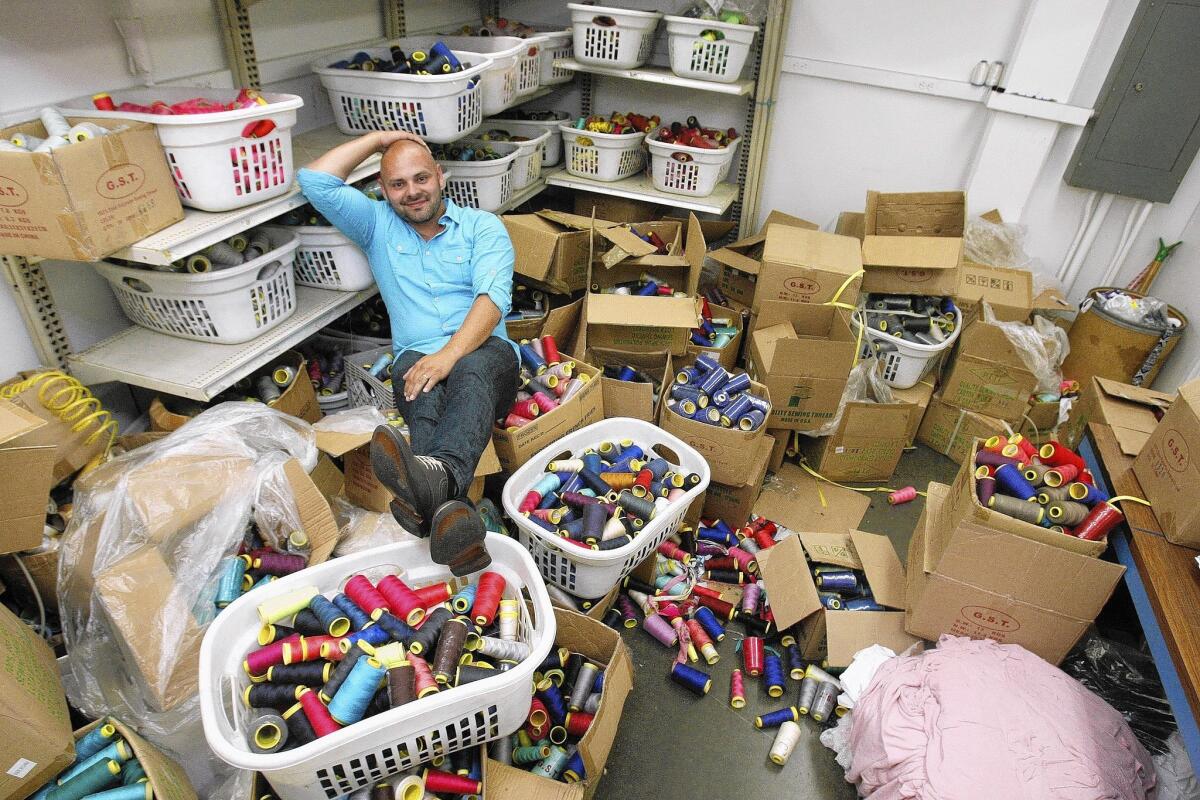Garment broker Mike Angel Reynoso in the thread room at the Rong Li Fashion factory in Arcadia.