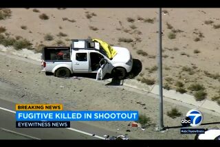 This image from video provided by KABC-TV shows a truck owned by Anthony John Graziano after a shootout on a highway in Hesperia, Calif., on Tuesday, Sept. 27, 2022. The Southern California man who was accused of killing his estranged wife and abducting their 15-year-old daughter had been living with the teenager out of his pickup truck and hotels for weeks before the violence, authorities said Wednesday, Sept. 28, 2022. (KABC-TV via AP)