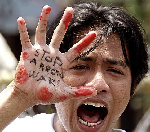 A student protester shouts during a rally in Manila, Philippines, demonstrating against violence in the country's south that erupted after the aborted signing of a preliminary accord with Muslim rebels.