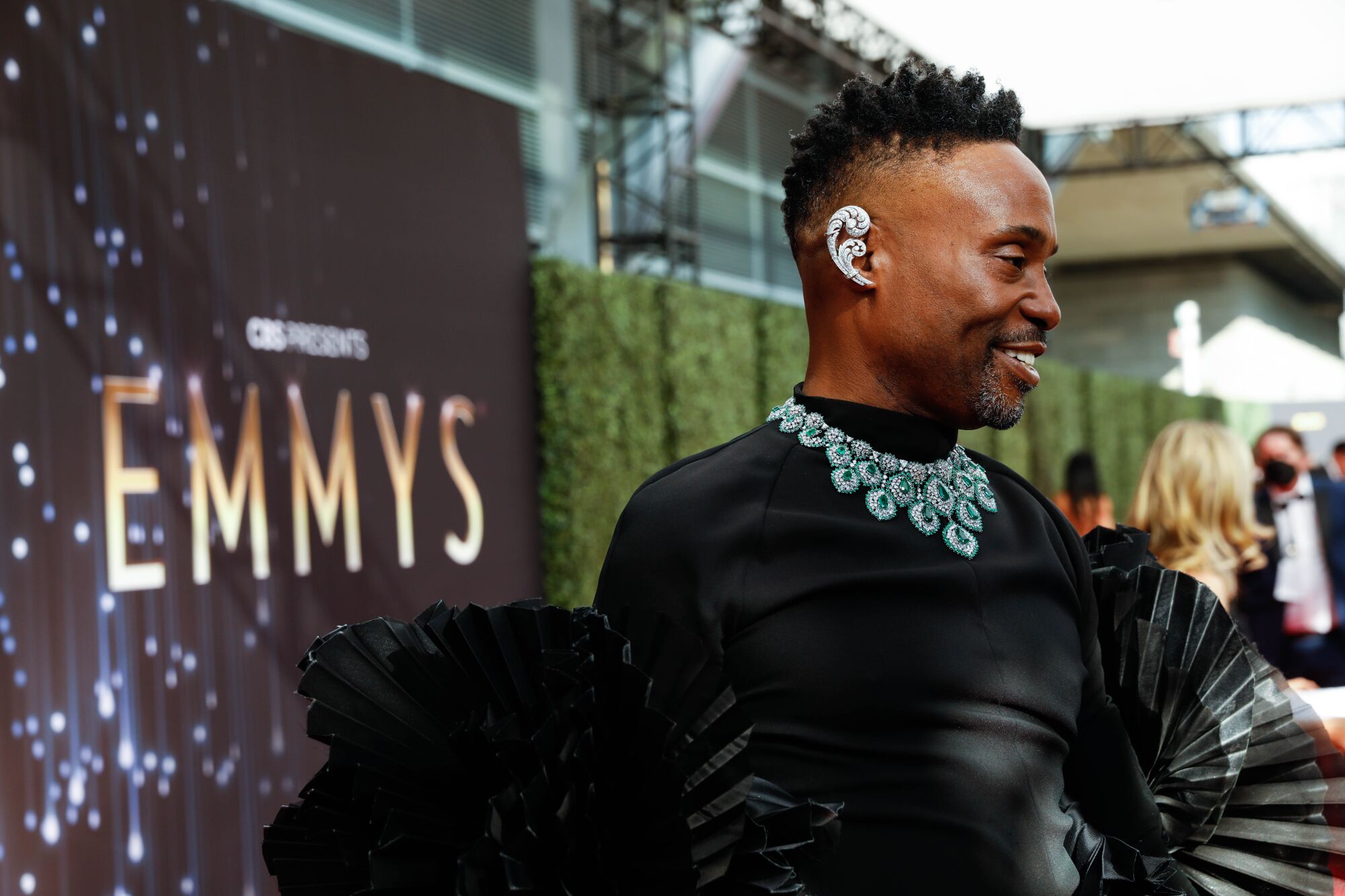 Billy Porter smiles as he walks the Emmys red carpet.