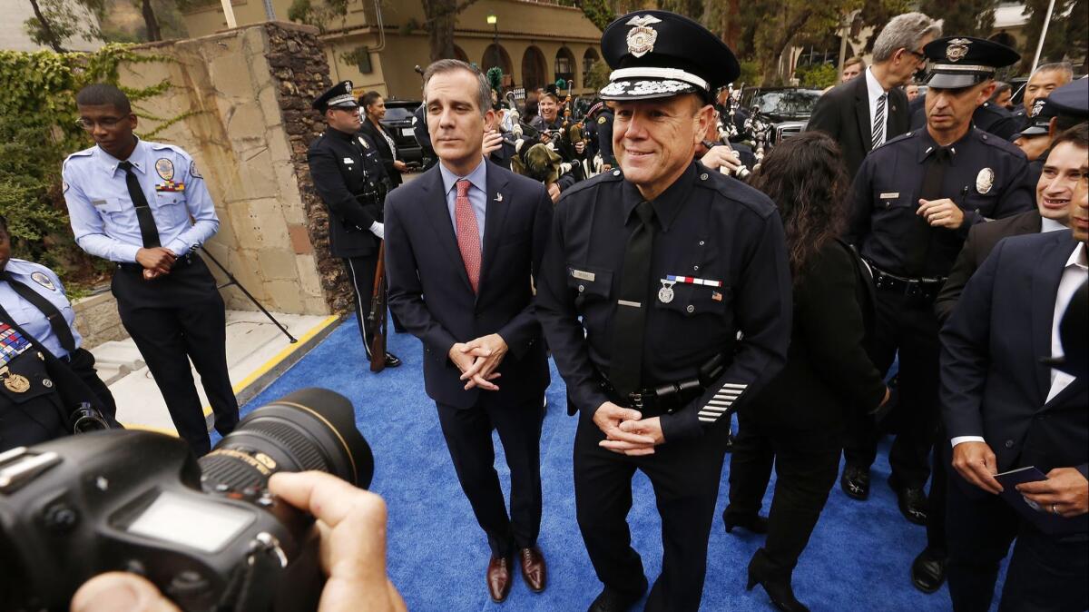 Los Angeles Mayor Eric Garcetti, left, with LAPD Chief Michel Moore, right, in Los Angeles on June 28.