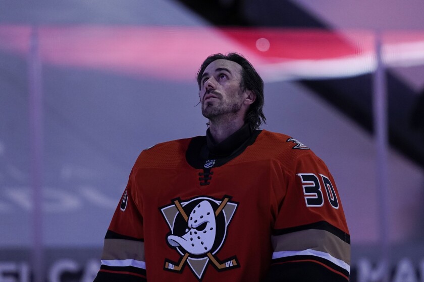 Anaheim Ducks goaltender Ryan Miller listens to the national anthem before the team's NHL hockey game against the Los Angeles Kings, Saturday, May 1, 2021, in Anaheim, Calif. Miller will retire at the conclusion of the season, ending the 18-year career of the winningest American-born goaltender in NHL history. (AP Photo/Jae C. Hong)