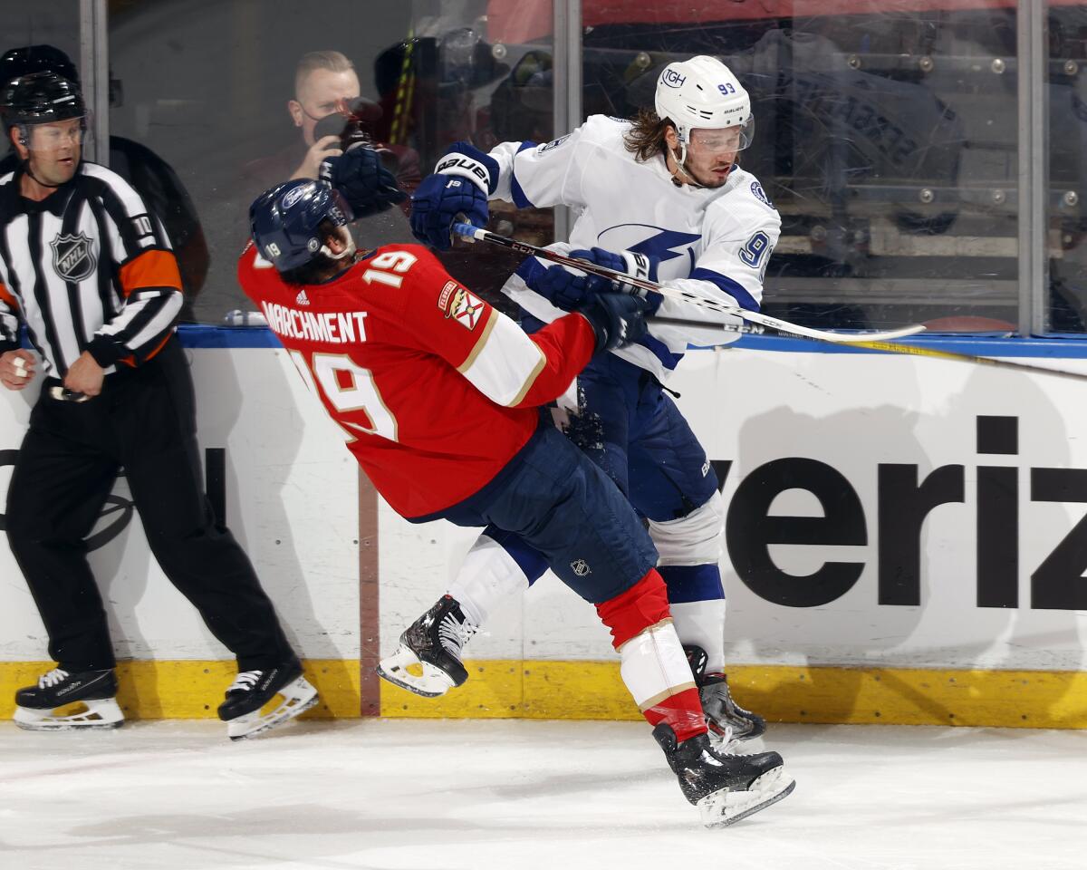 Tampa Bay Lightning center Steven Stamkos (91) checks Florida Panthers left wing Mason Marchment (19) during the third period in Game 1 of an NHL hockey Stanley Cup first-round playoff series, Sunday, May 16, 2021, in Sunrise, Fla. (AP Photo/Joel Auerbach)
