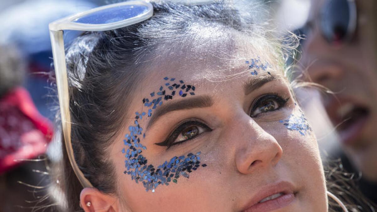 A glitter-flecked fan watches Stormzy perform at the Outdoor Stage on Friday at Coachella.