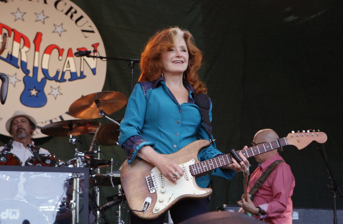 Bonnie Raitt performs onstage.