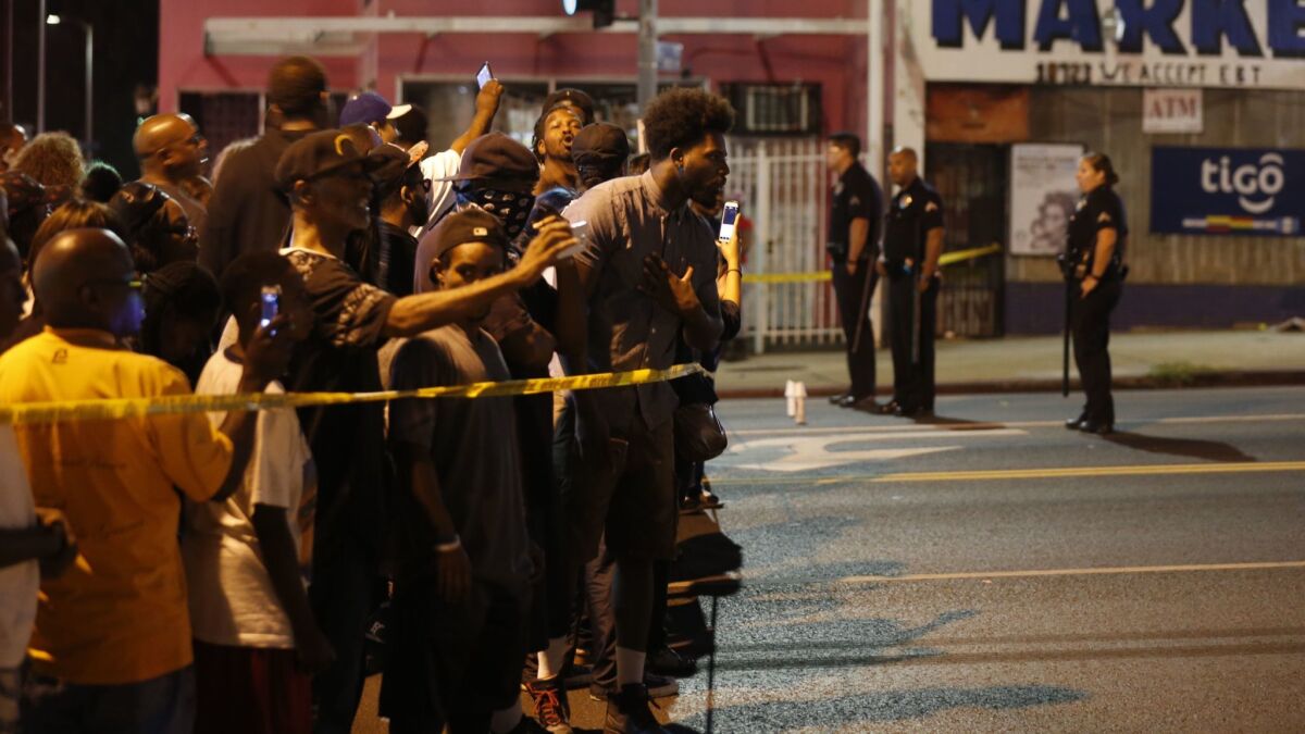 A crowd protests the deadly 2016 LAPD shooting of 18-year old Carnell "CJ" Snell in South Los Angeles.