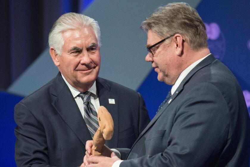 US Secretary of State Rex Tillerson hands the Arctic Council chair's gavel to Finnish Foreign Minister Timo Soini (R) as Finland becomes the chair during the plenary session of the Arctic Council meeting in Fairbanks, Alaska, on May 11, 2017. / AFP PHOTO / NICHOLAS KAMMNICHOLAS KAMM/AFP/Getty Images ** OUTS - ELSENT, FPG, CM - OUTS * NM, PH, VA if sourced by CT, LA or MoD **