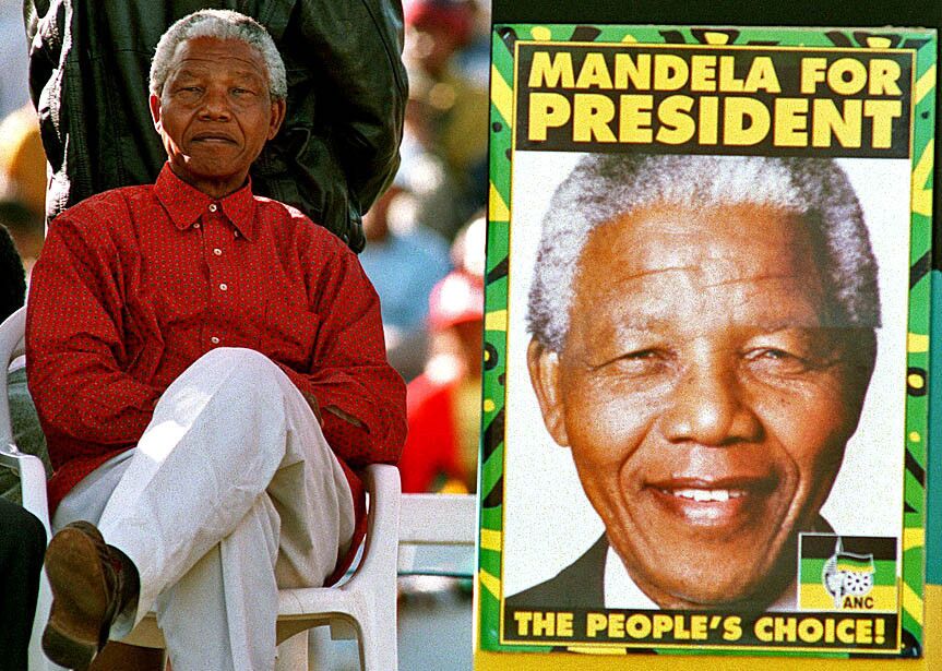 Nelson Mandela listens to speakers at a campaign rally at Soweto Stadium before addressing the crowd himself on April 23, 1994, three days before national elections.